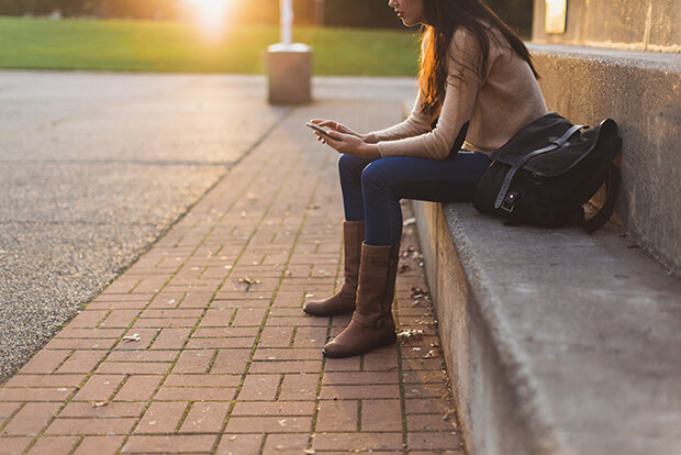 long haired girl, boots, sitting outside