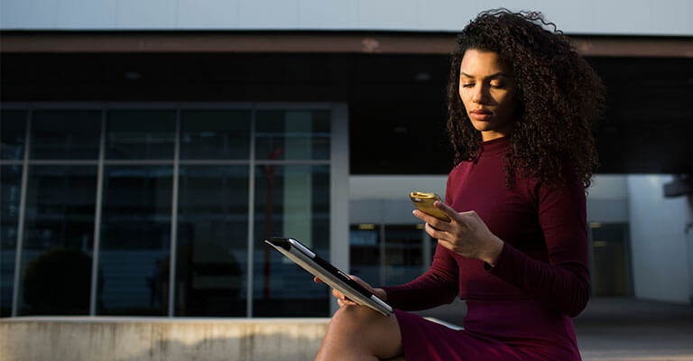 Woman holding tablet on smartphone