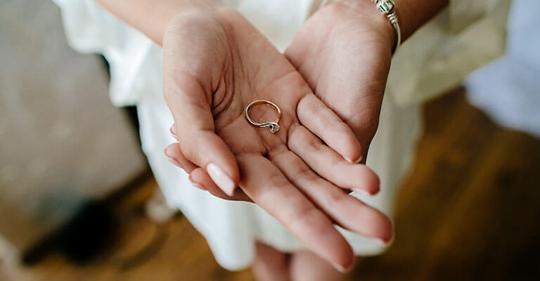 Woman's hands holding engagement ring