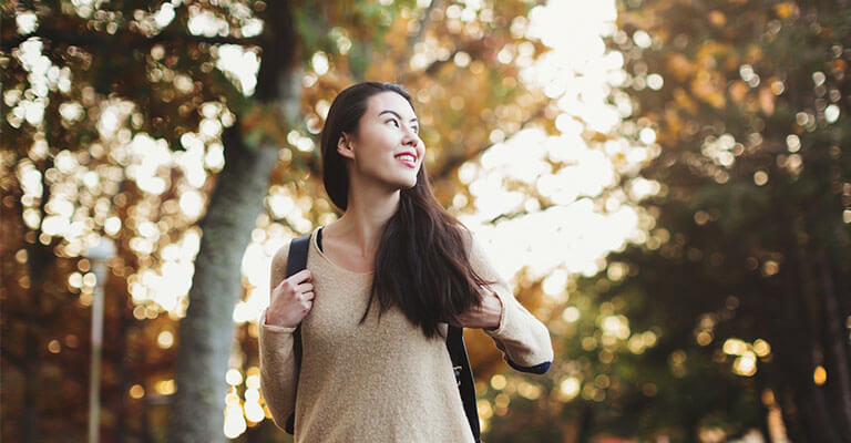 College student outside with backpack