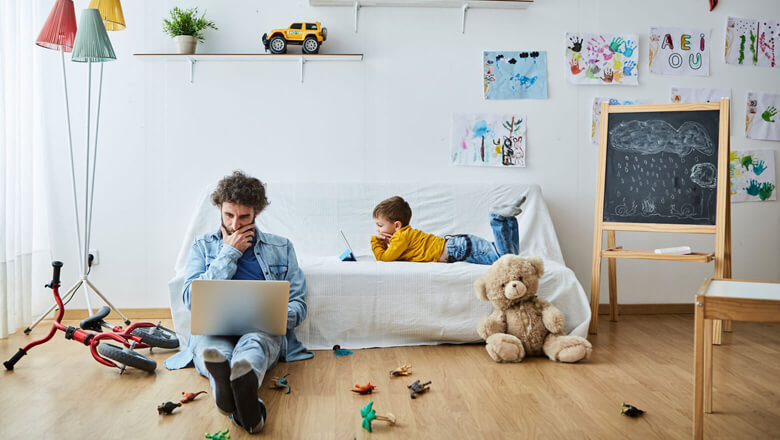 father on laptop with his child