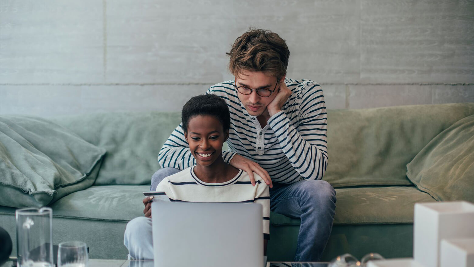 couple on the couch on their computer