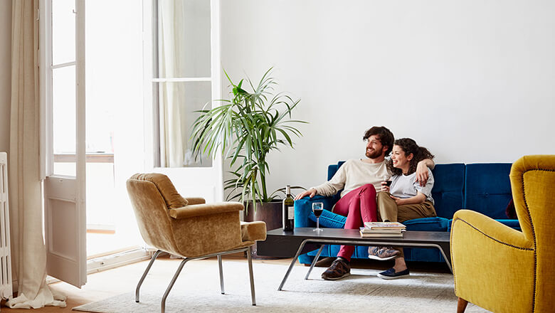 Couple having wine on couch