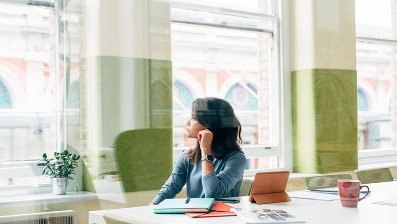 Woman in office looking out window