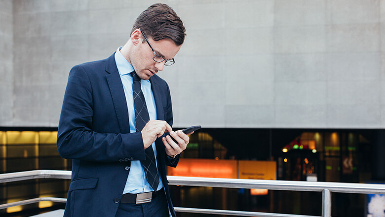 man in suit on smartphone