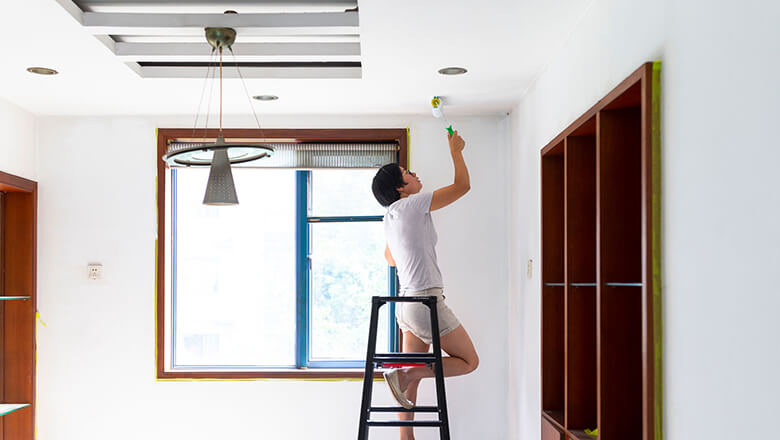 woman painting her ceiling