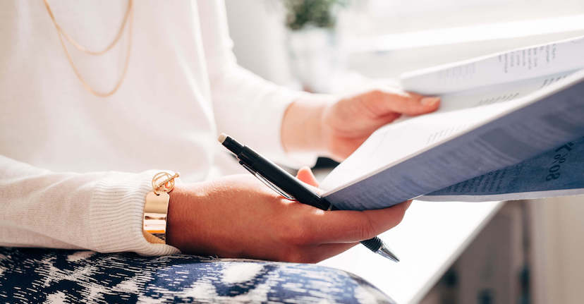 woman reading paper