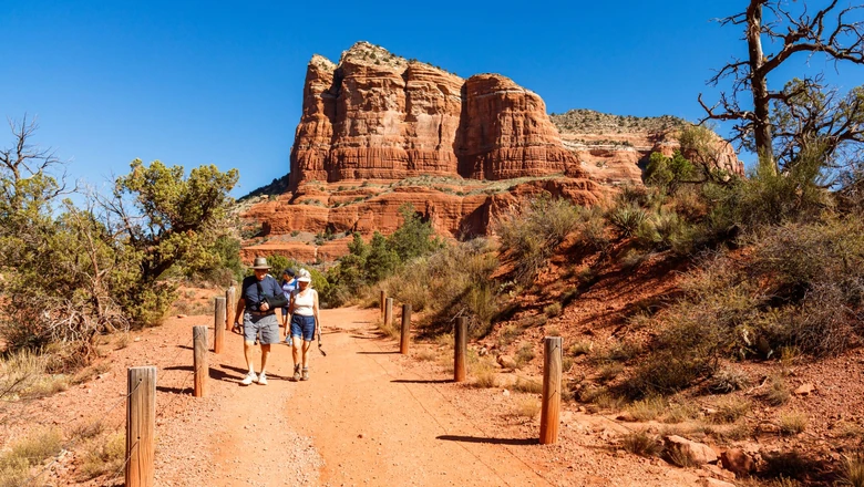A retired couple hiking on a trail in Arizona.