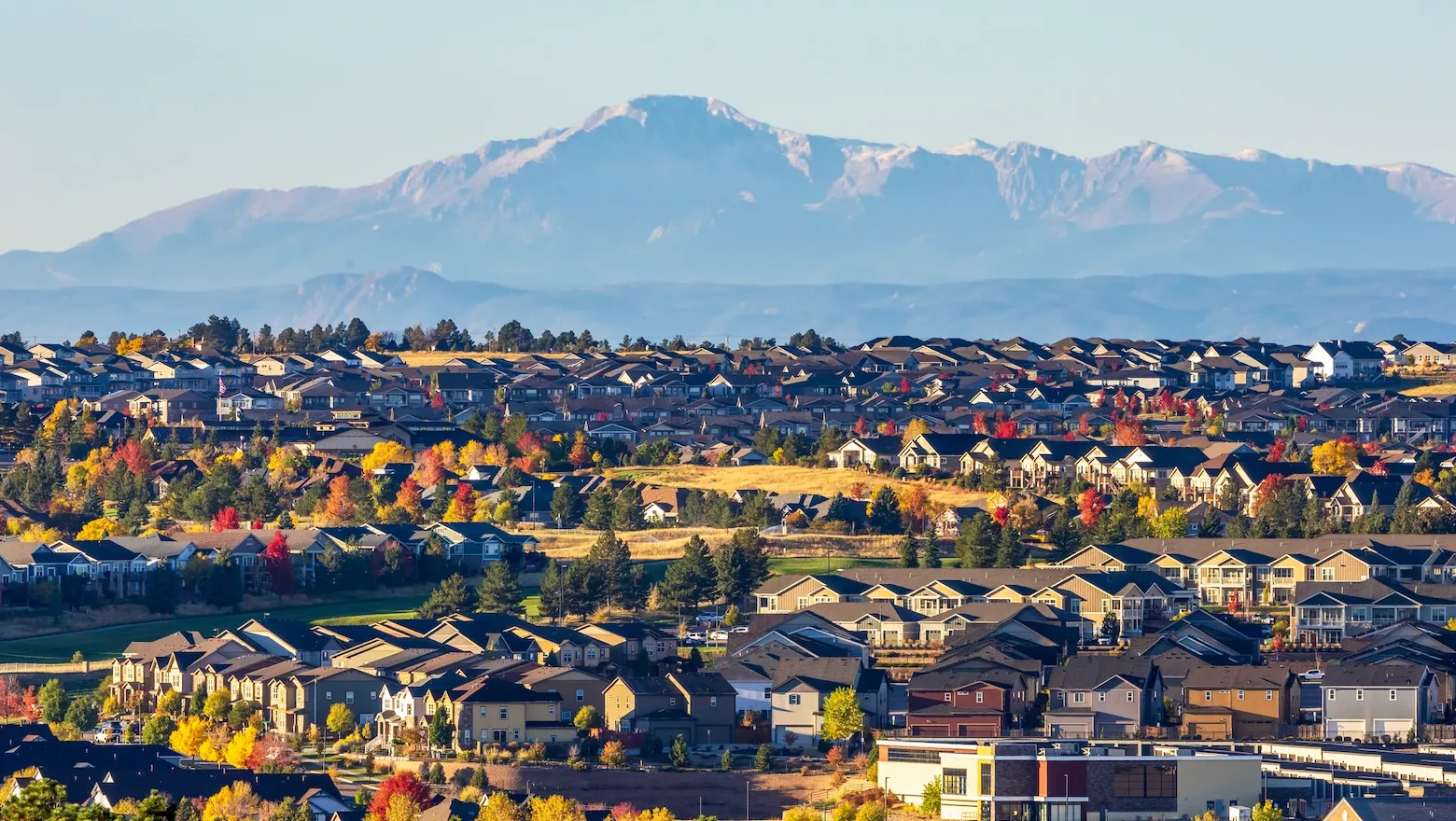 A wide view of homes in Colorado with mountains in the distance.