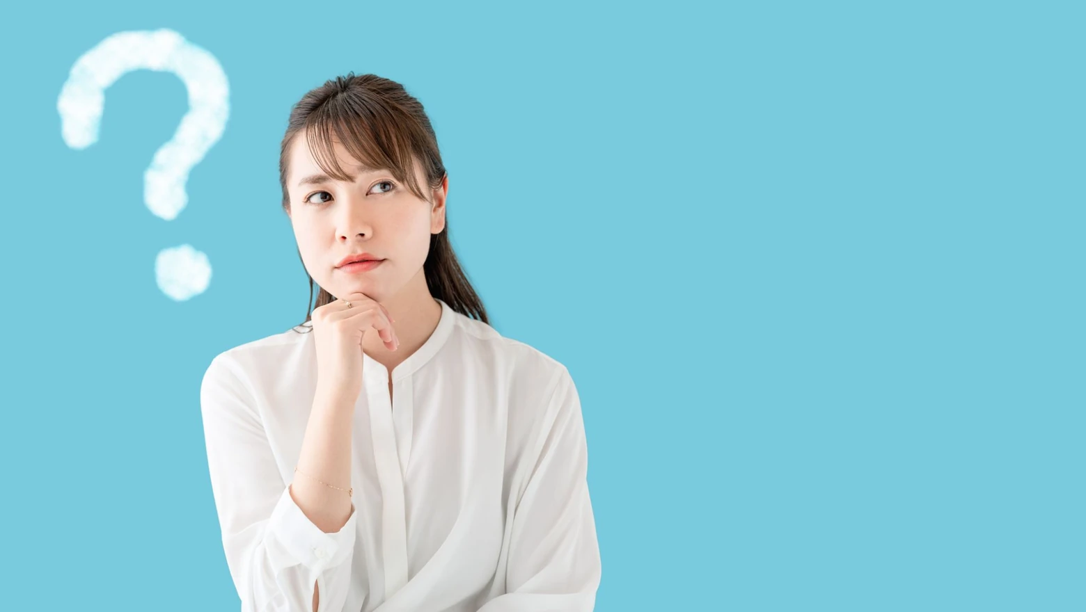 A woman looks thoughtful beside a question mark graphic, weighing SoFi Credit Card vs. Chase Freedom Unlimited options.