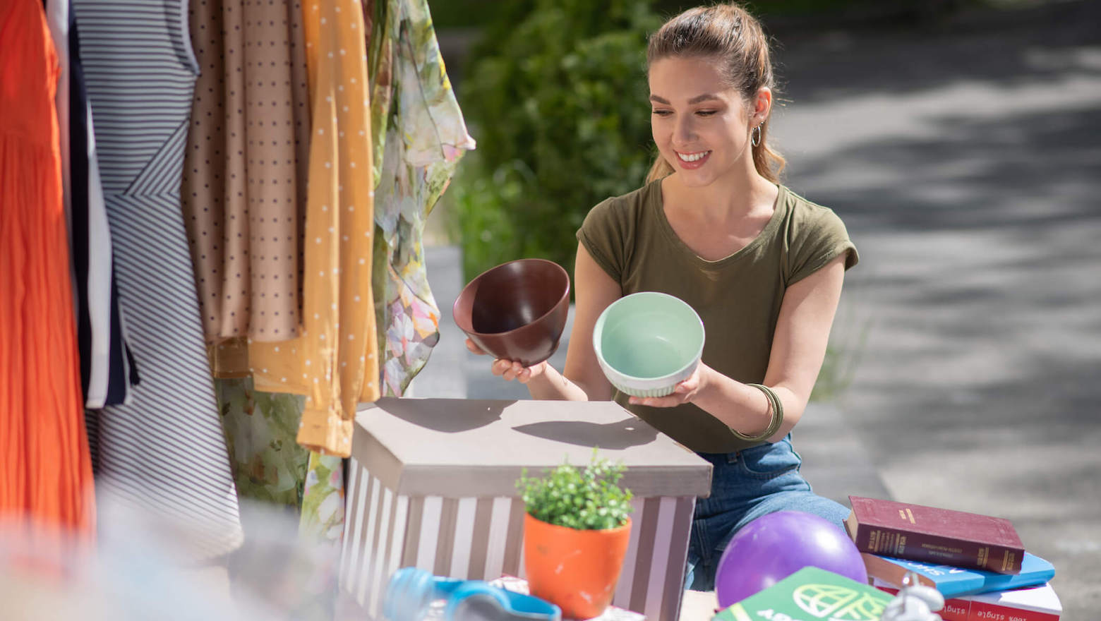 young woman selling bowls at market