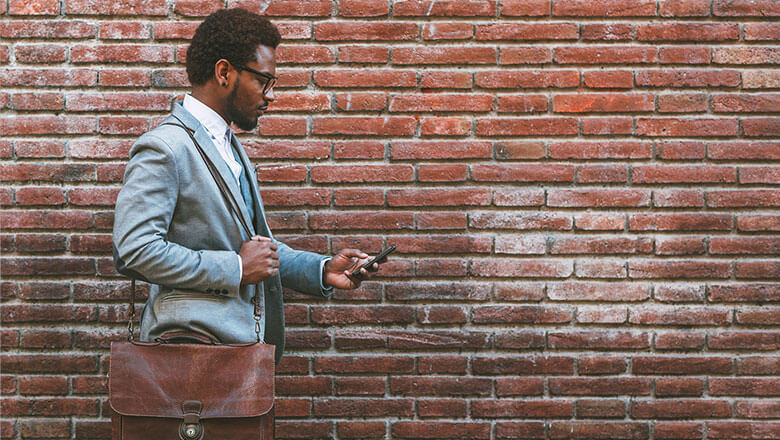 businessman on phone with brick wall