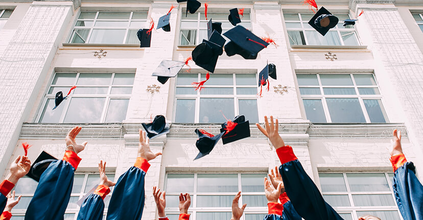 Grads throwing caps