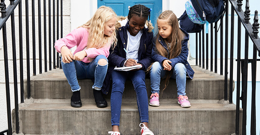 girls reading on stoop