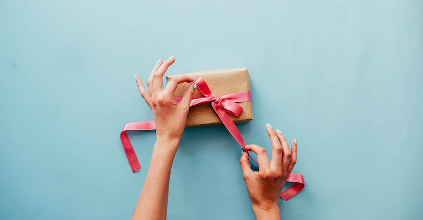 hands wrapping a gift