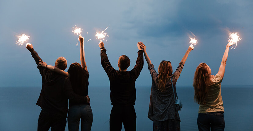 friends holding sparklers