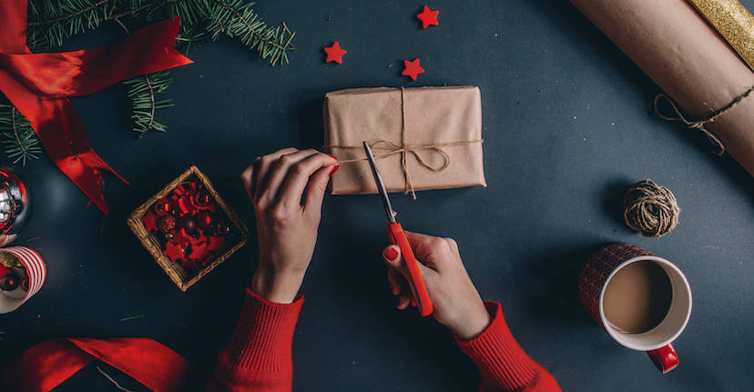 hands wrapping holiday gift