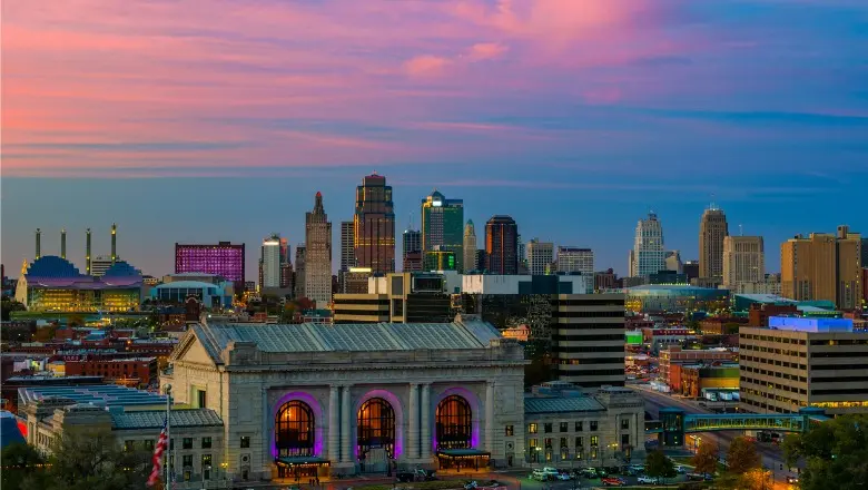 A wide-angle shot of the Kansas City skyline at dusk, with the historic Union Station in the foreground.