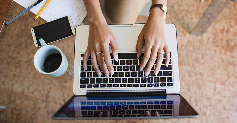 someone typing on a laptop