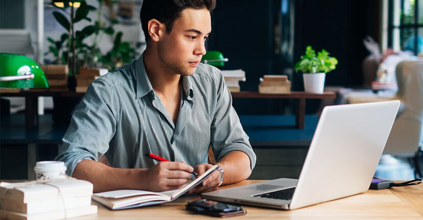 man at desk with laptop