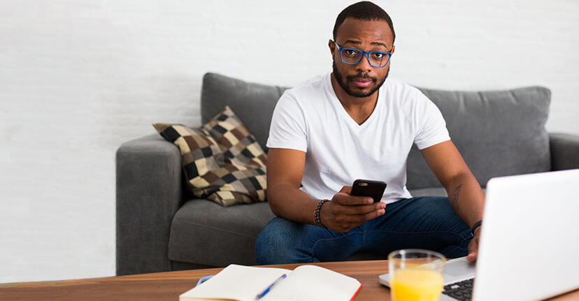 man on couch with phone