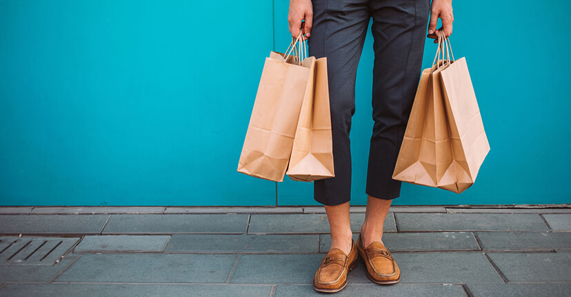 man holding shopping bags