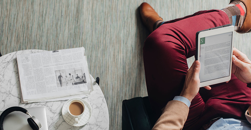 man on tablet with coffee