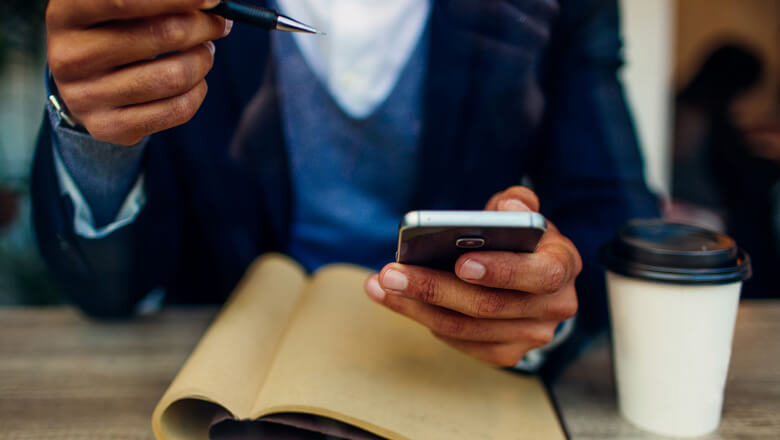 man with phone and notebook mobile