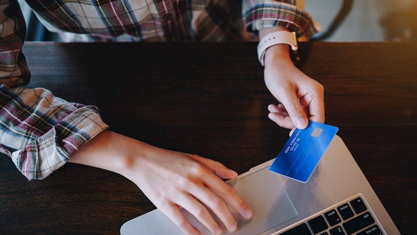 person holding blue credit card