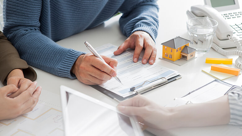 man signing mortgage paperwork