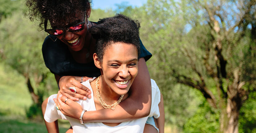 woman giving sibling piggyback