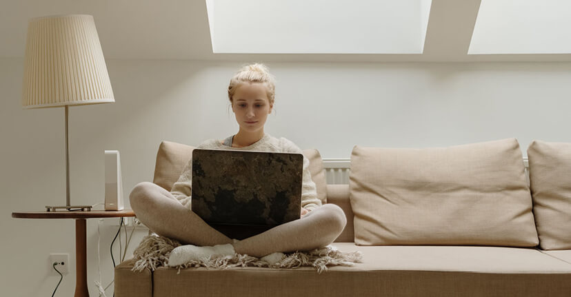 woman on laptop on couch