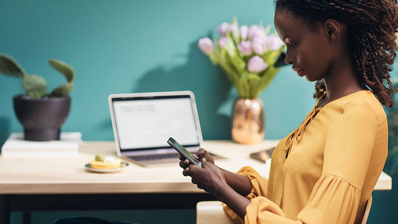 woman in office on smartphone