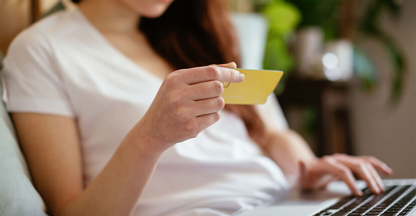 woman on laptop with credit card