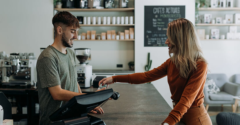 woman paying at cafe