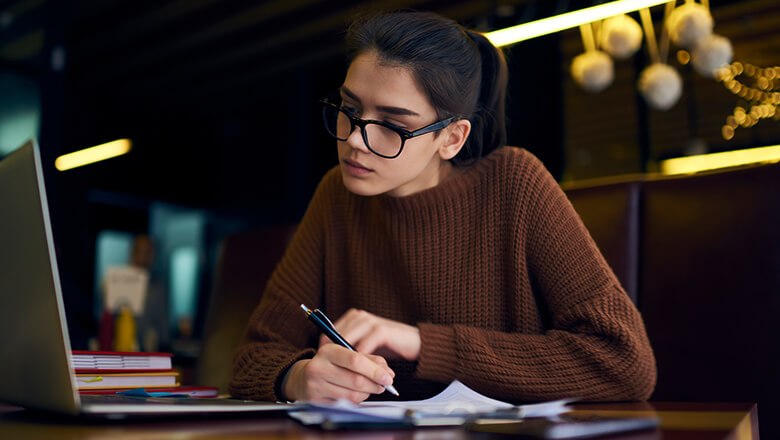 student on laptop in library